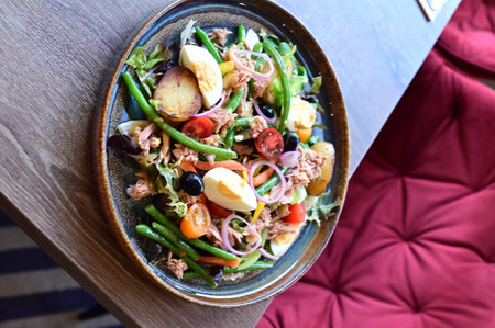 Salad with tuna and vegetables on a plate in a restaurant.