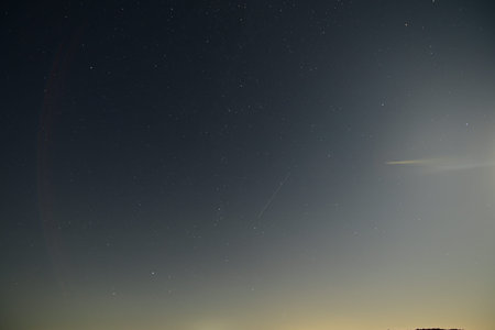 Night sky with stars and a comet in the starry sky.