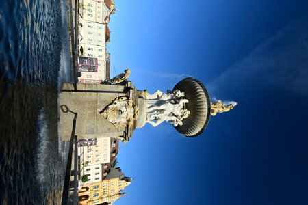 The Fountain of Neptune located at the historic town square of ÄeskÃ© BudÄjovice, Czech Republic, showcasing Baroque architecture and vibrant city atmosphere.の写真素材