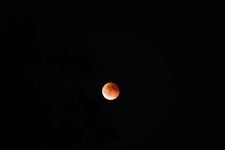 Lunar eclipse over HnÄvoÅ¡ice, Silesia, Czech Republic, on a clear night of September 7, 2025. The moon is partially covered by the Earth's shadow, creating a stunning celestial pheの写真素材