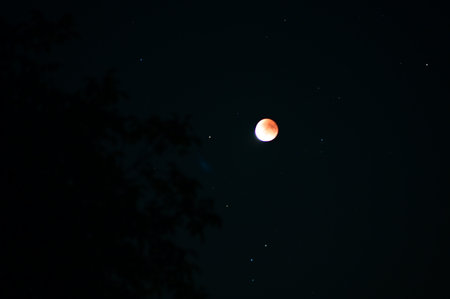 Lunar eclipse over HnÄvoÅ¡ice, Silesia, Czech Republic, on a clear night of September 7, 2025. The moon is partially covered by the Earth's shadow, creating a stunning celestial pheの写真素材