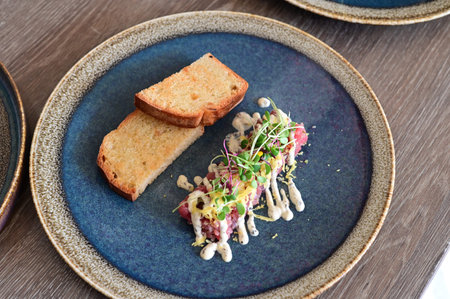 Beef tartare with toasted bread and microgreens.
