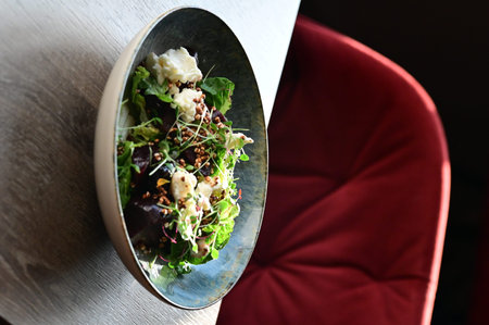 Plate with salad on table in cafe, closeup. Food delivery service