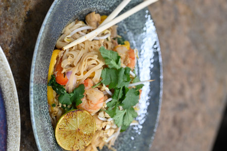 Noodles with prawns and vegetables in a bowl.