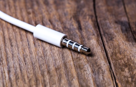 plug headphones on wooden backgroundの写真素材