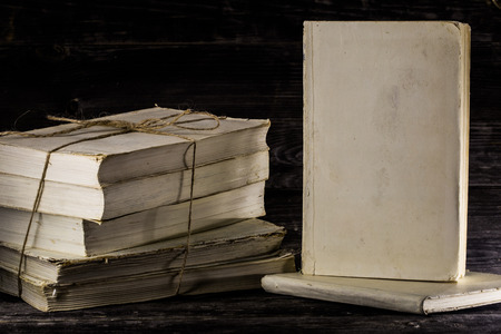 stacked books on a wooden background, place for textの写真素材