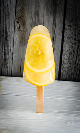 different ice-cream fruit, frozen fruits on wooden backgroundの写真素材