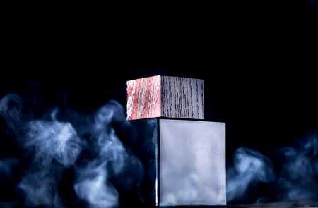 the jar of perfume on a background of smoke, black backgroundの写真素材