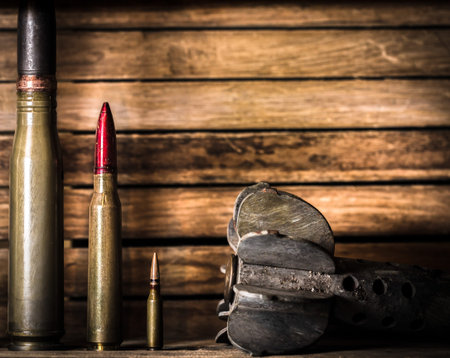 weapons, cartridge on wooden background, place for text