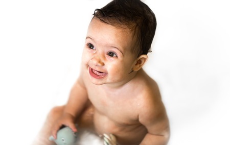 emotions of a little girl on a white background, in the bathroomの写真素材