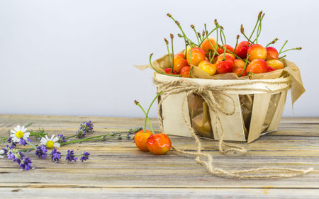 fresh berries, sweet cherries in basket on white background, foodの写真素材