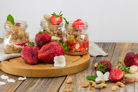 fresh berries, strawberry, glass jar with Breakfast on wooden backgroundの写真素材
