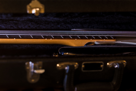 bass guitar in the open case, musical instrument on black backgroundの写真素材