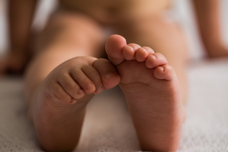 baby feet in white blanket, close upの写真素材