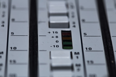 the fader on a mixing console with volume meter, closeupの写真素材