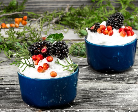 beautiful Christmas cupcake with cream and berry on wooden background cinnamon Cup red bumpsの写真素材