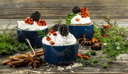 beautiful Christmas cupcake with cream and berry on wooden background cinnamon Cup red bumpsの写真素材
