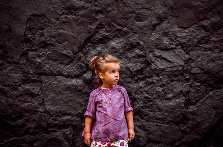 emotion girl sitting near wall in the day time, beautiful background