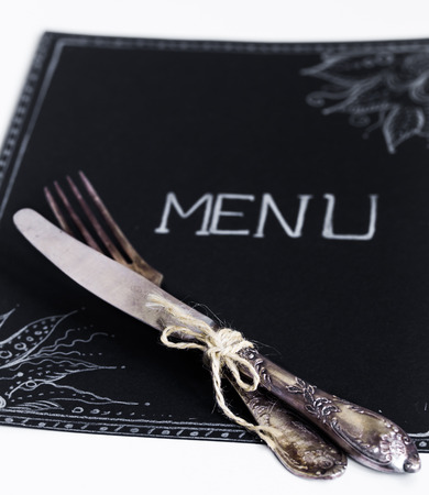 Cafe menu restaurant on the black sheet with white background and beautiful Cutleryの写真素材