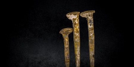 old large rusty nails on black backgroundの写真素材