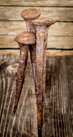 very old large nails on a beautiful wooden background, rusty nails, there is a place for textの写真素材