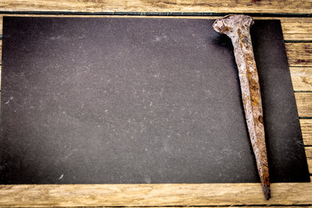 very old large nails on a beautiful wooden background, rusty nails, there is a place for text