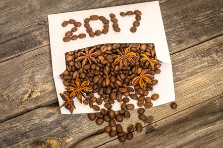 New 2017 from coffee beans on a white envelope and a wooden backgroundの写真素材