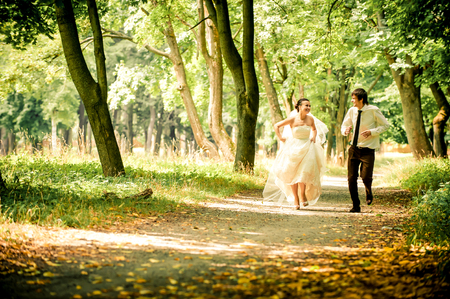 happy bride and groom on a walk in a beautiful forest, true loveの写真素材