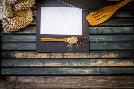 The cozy kitchen still life on wooden background.Place for text on white sheet of paper with a...