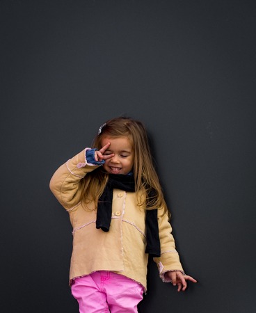 beautiful stylish girl in black background wall, cheerful emotions girls, perky girlの写真素材