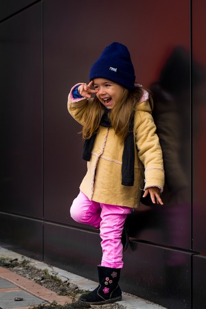 beautiful stylish girl in black background wall, cheerful emotions girls, perky girlの写真素材