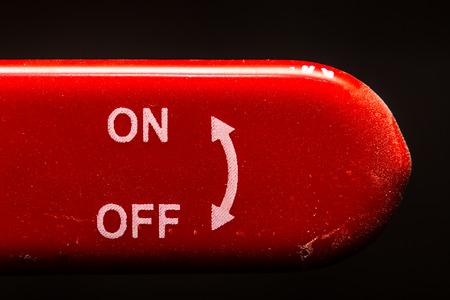 the red lever on off switch on dark background, closeupの写真素材