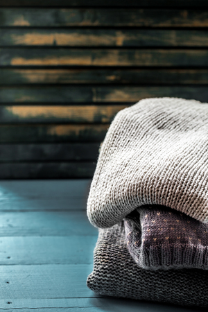 Cozy and soft sweater in a beautiful ornament on wooden blue backgroundの写真素材