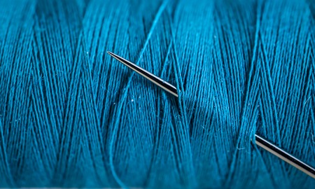Sewing thread beautiful colors with needle closeupの写真素材