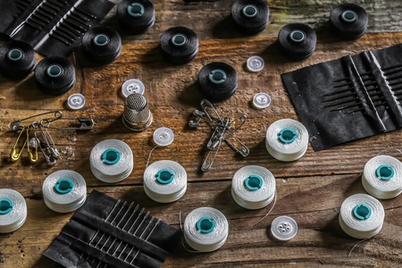 set of sewing threads and accessories on wooden background contrast individually.の写真素材