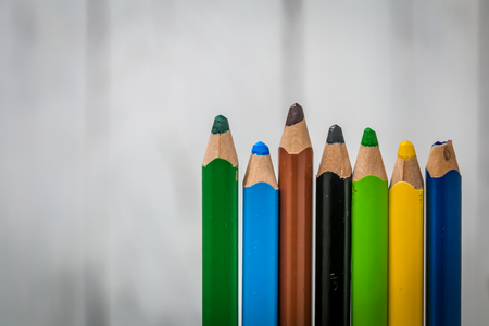 large colored pencils laid out neatly on nice wooden backgroundの写真素材