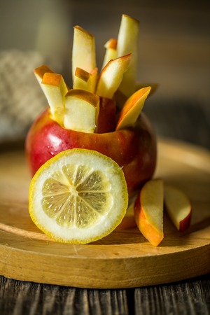 Still life with apples on wooden background . Apples cut into strips.の写真素材