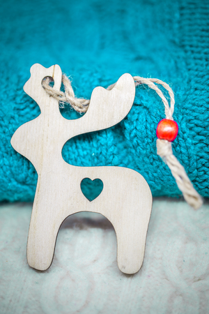 Christmas wooden toys on the background of the sweater closeupの写真素材