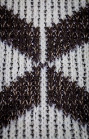 beautiful cozy knitted geometric pattern sweater closeupの写真素材