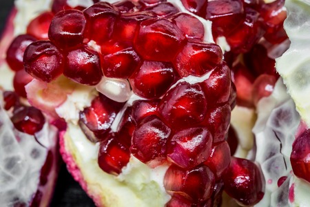 Fresh broken pomegranate on black background ,macroの写真素材