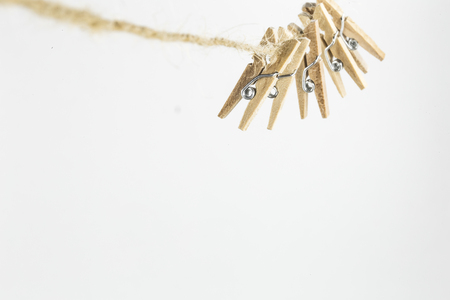 pretty little decorative clothespins weigh on the rope, isolated on white backgroundの写真素材