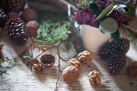 Christmas composition cones with nuts on wooden backgroundの写真素材