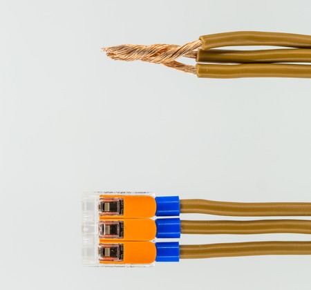 connecting electrical cables to the terminal block isolated on white background, closeupの写真素材