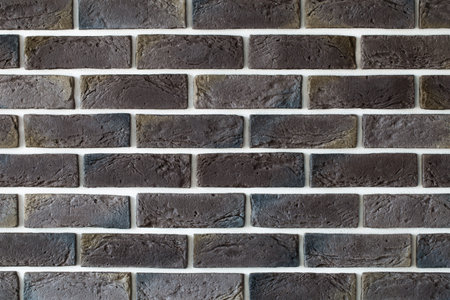 Dark brown brick wall ,creative back-phonon ,closeup