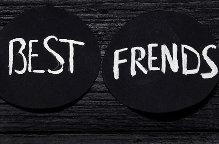 black circle with white lettering on a black wooden backgroundの写真素材