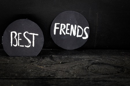 black circle with white lettering on a black wooden backgroundの写真素材