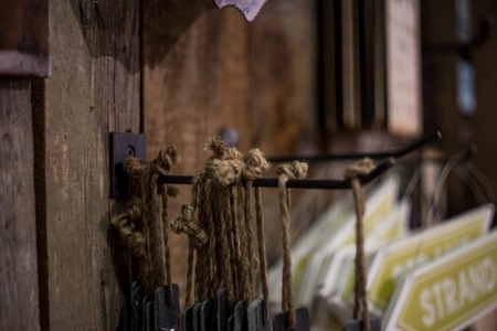 rope hanging on the hook in the store on a wooden backgroundの写真素材