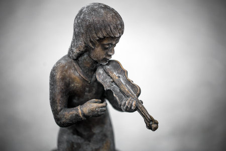 Statues of children playing musical instruments on the street of Germanyの写真素材
