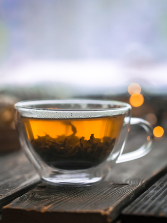 Beautiful transparent Cup custard tea on wooden backgroundの写真素材