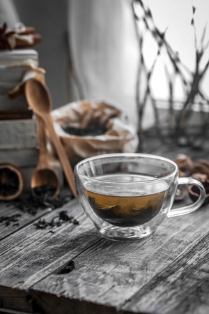 still life with transparent and fragrant Cup of tea with ginger on wooden backgroundの写真素材